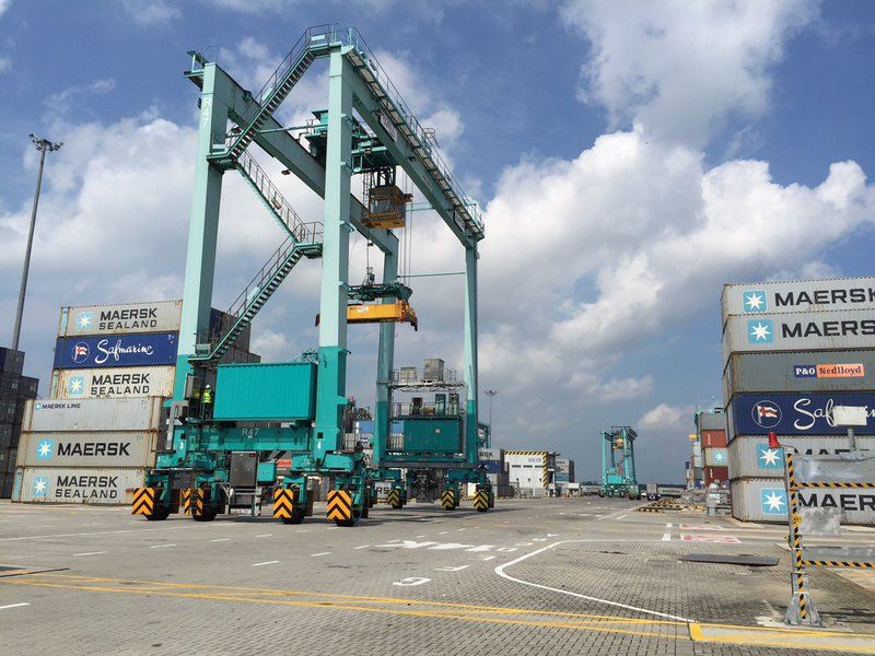 Rubber-tired container gantry crane operating between container stacks