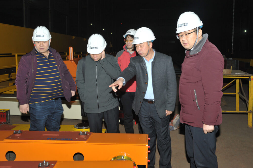 Customer visitors inspecting crane equipment with the Henan Mine Crane team