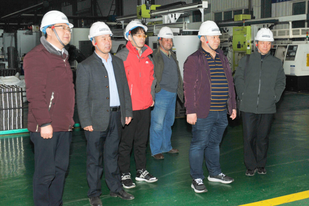 Customer visitors and Henan Mine Crane team members in the workshop