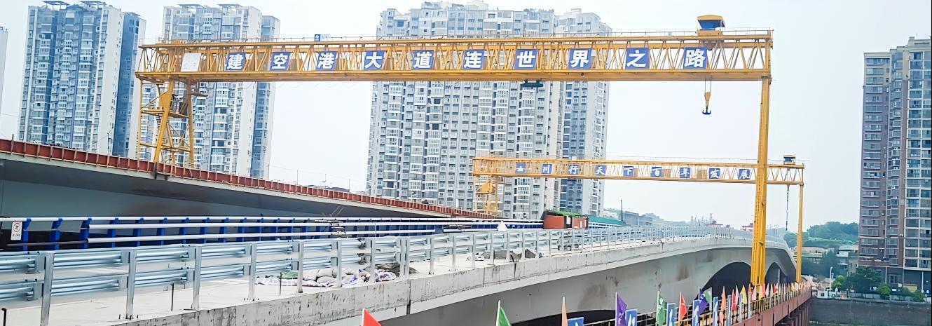 Long-span gantry crane beside an urban bridge construction site