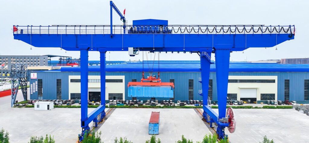 Henan Mine Crane rail-mounted container gantry crane lifting a container in an outdoor yard