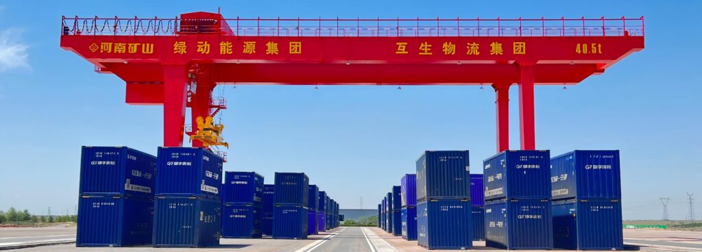 Rail-mounted gantry crane handling containers at a dry port