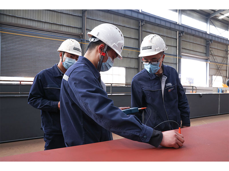 Quality team inspecting crane fabrication and assembly processes