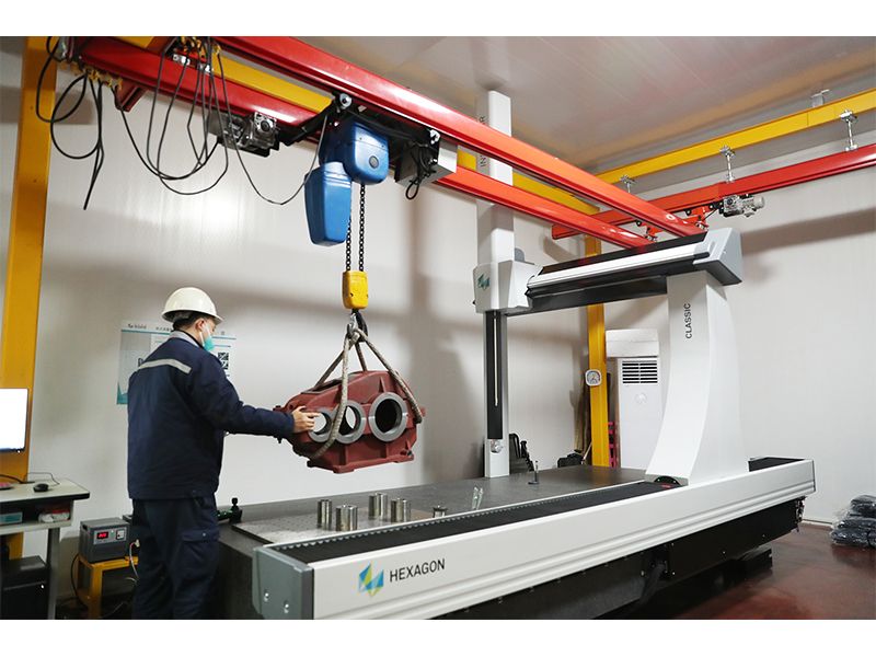 Quality specialists checking crane welds, gears and assembled components