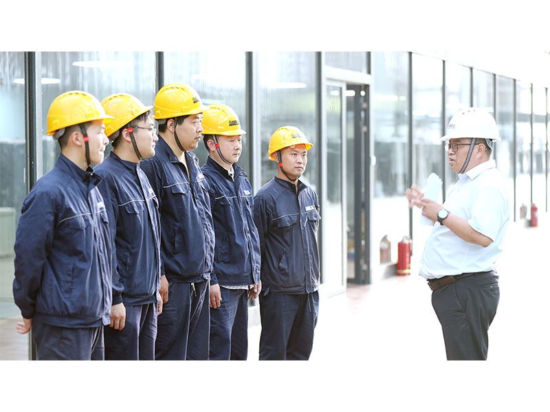 Electrical workshop manager Li Chaoyong coordinating crane-component production