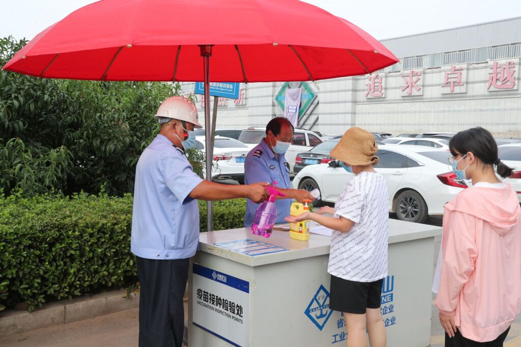 Factory staff implementing workplace health measures in August 2021