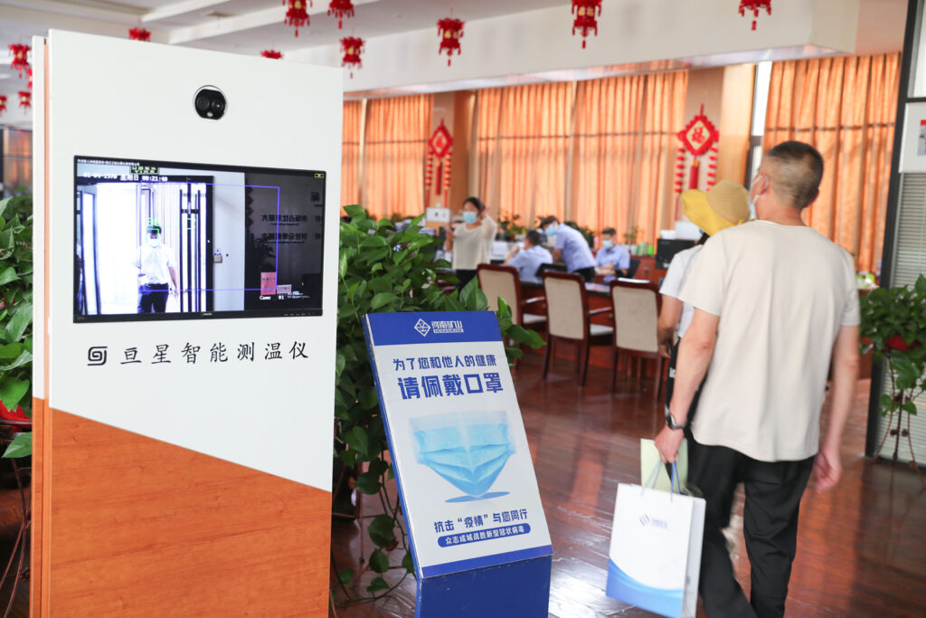 Factory staff implementing workplace health measures in August 2021