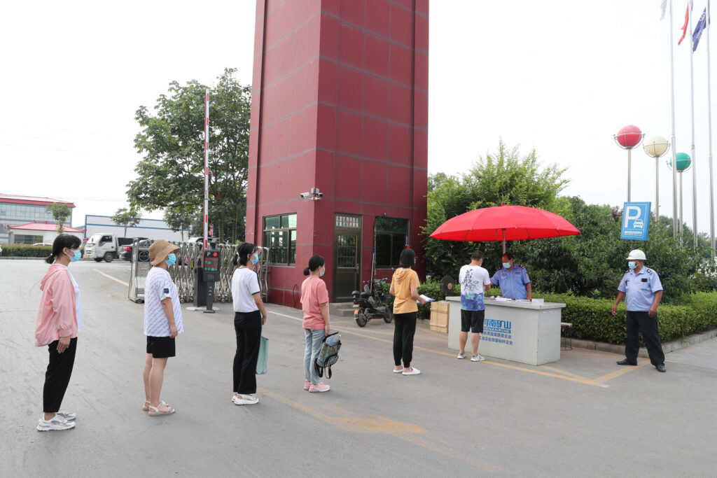 Factory staff implementing workplace health measures in August 2021