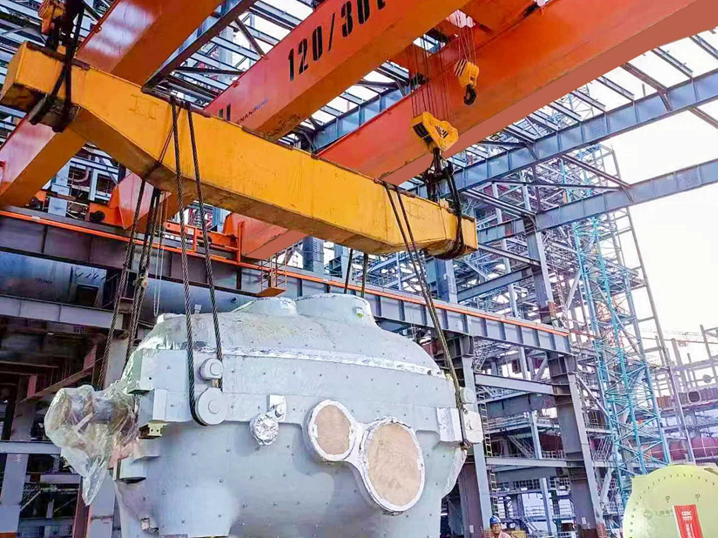 Overhead crane handling a thermal power plant installation component