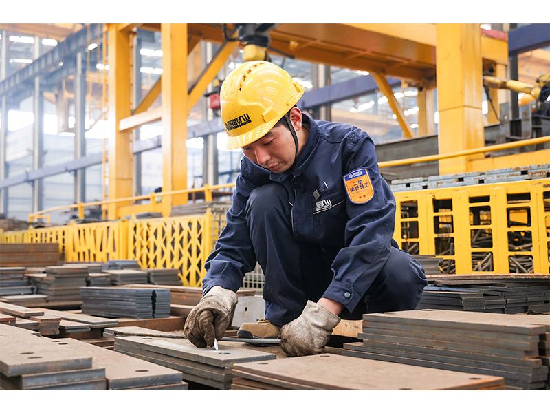 Welder Liu Chengjiang working on crane assembly components