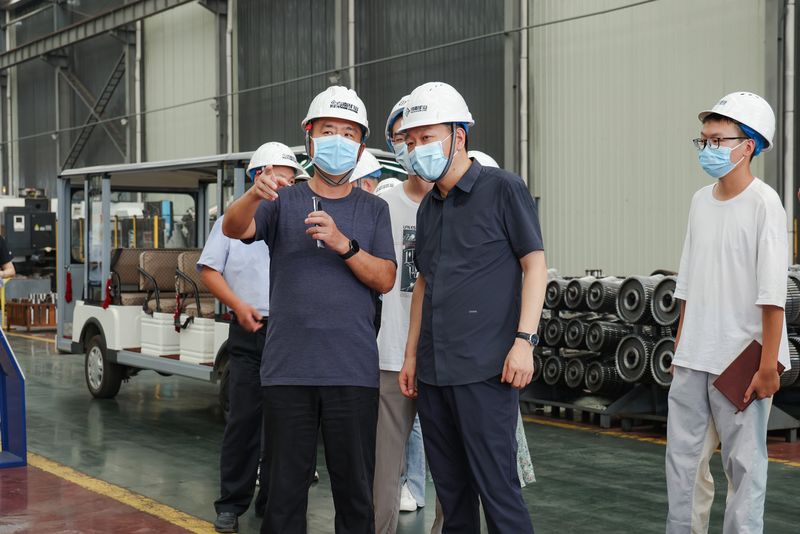 Visitors reviewing crane standards and manufacturing quality activities