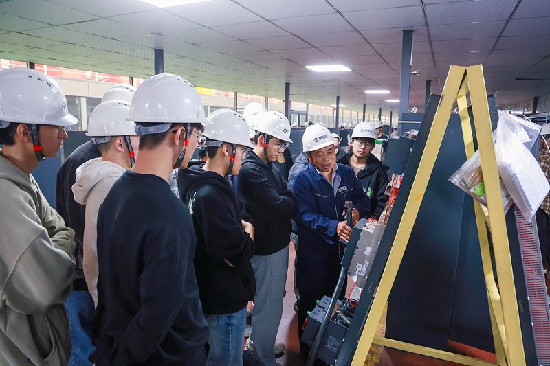 University Internship Connects Mechanical Engineering with Crane Production — image 4 University students receiving engineering instruction at the crane factory