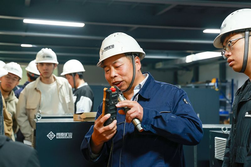 University Internship Connects Mechanical Engineering with Crane Production — image 6 University students receiving engineering instruction at the crane factory