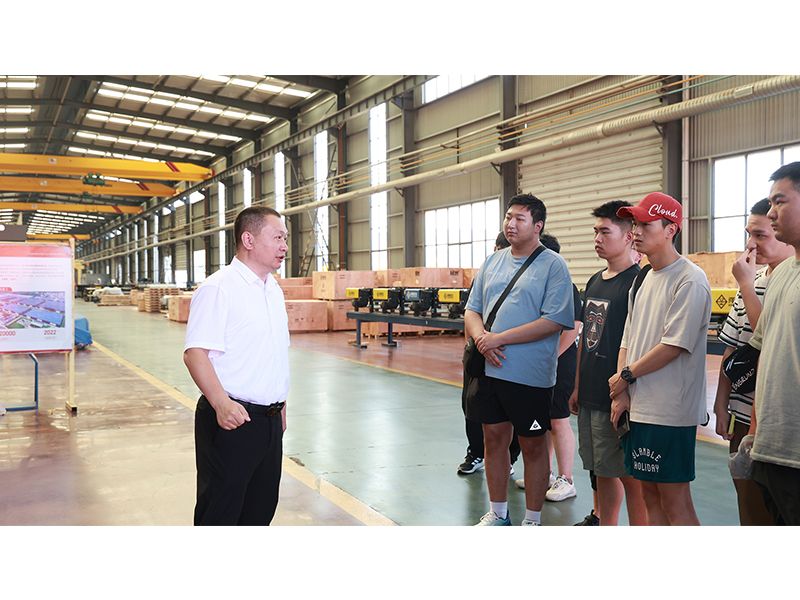 University visitors touring the crane manufacturing and testing facilities