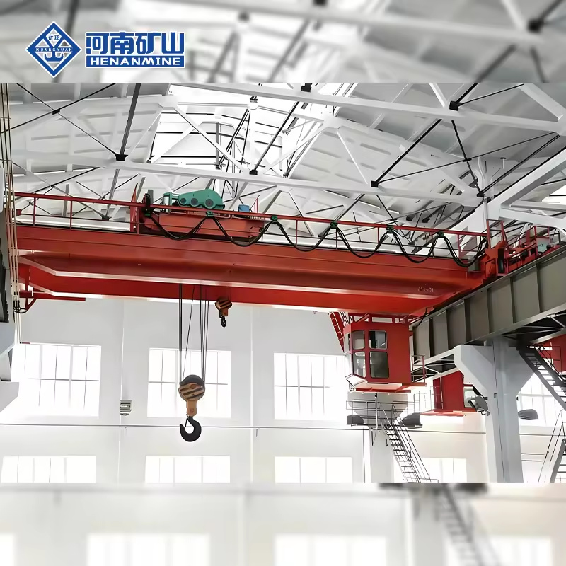 Red double-girder hook overhead crane with cabin and maintenance platform in a workshop