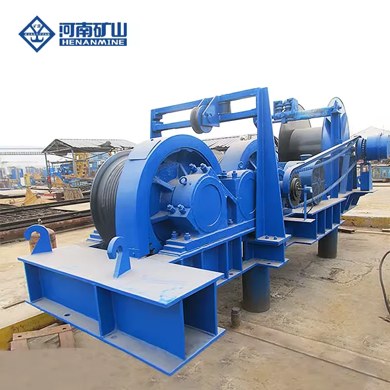 Large blue base-mounted electric wire rope winch photographed outdoors
