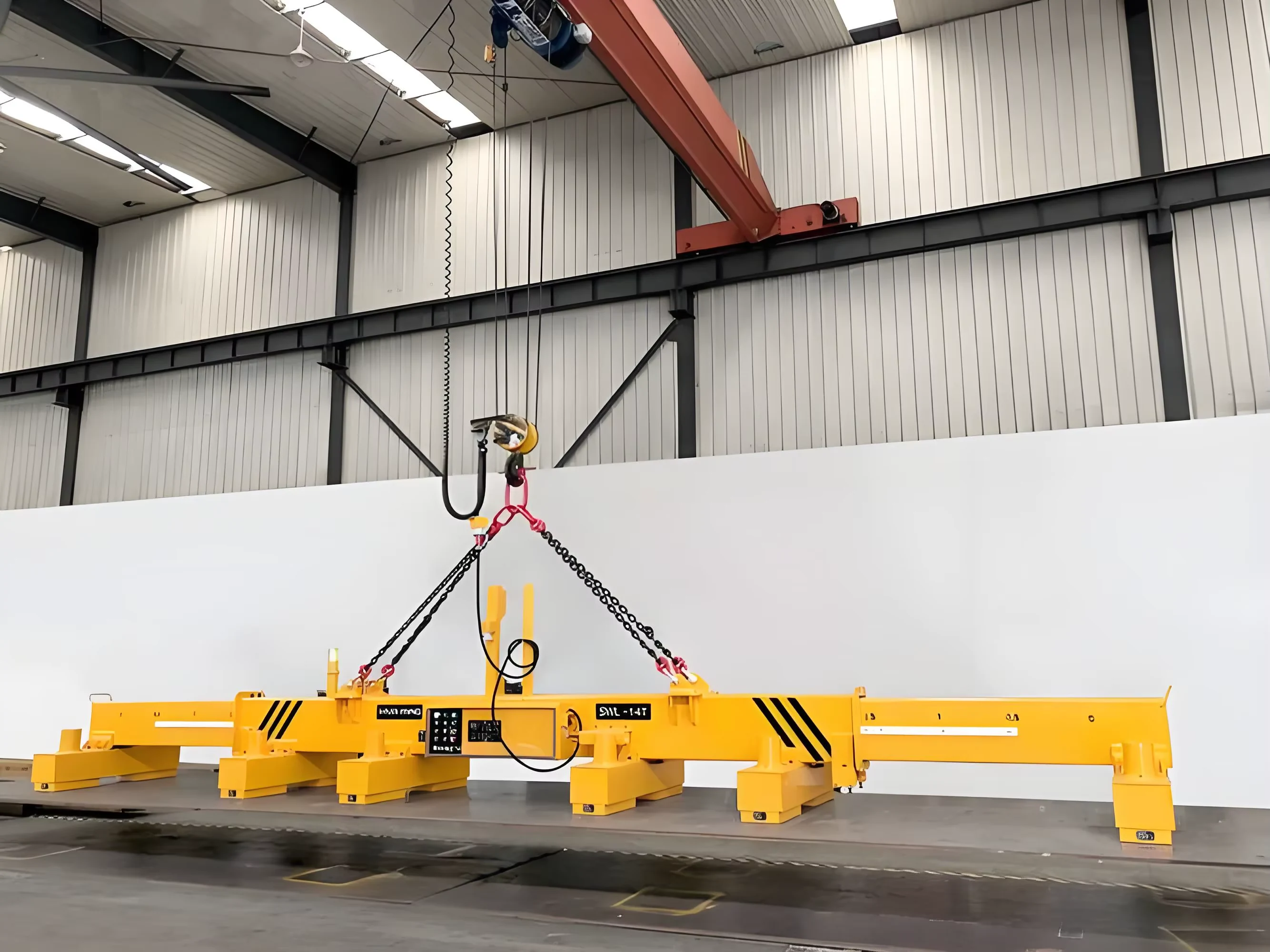 Full yellow magnetic lifting beam suspended inside a factory