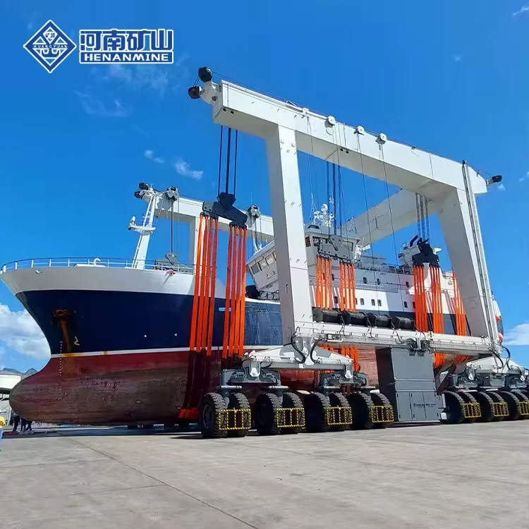White wheeled boat hoist carrying a dark-hulled vessel in slings beside the water