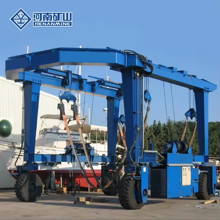Complete blue mobile boat hoist positioned around a vessel at a service yard