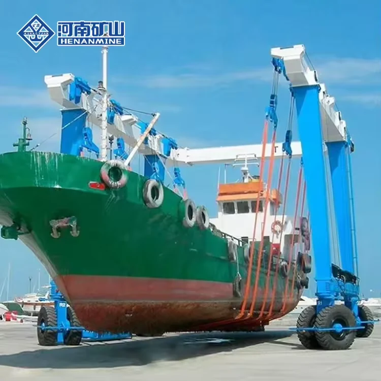 Blue mobile boat hoist lifting a green-hulled workboat
