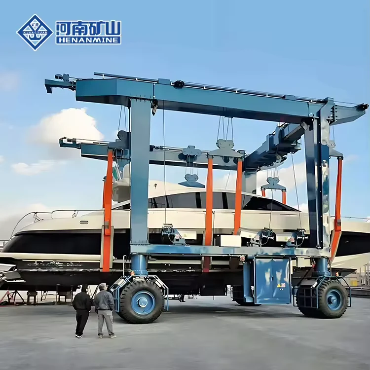 Gray mobile boat hoist carrying a white vessel across a yard