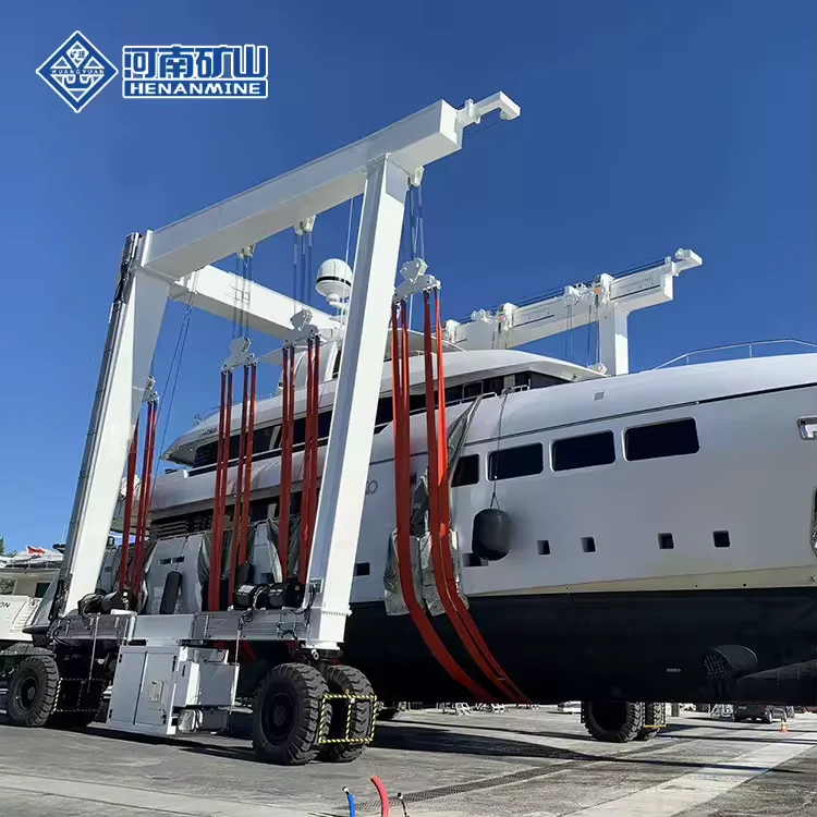White travel lift carrying a large yacht with multiple slings