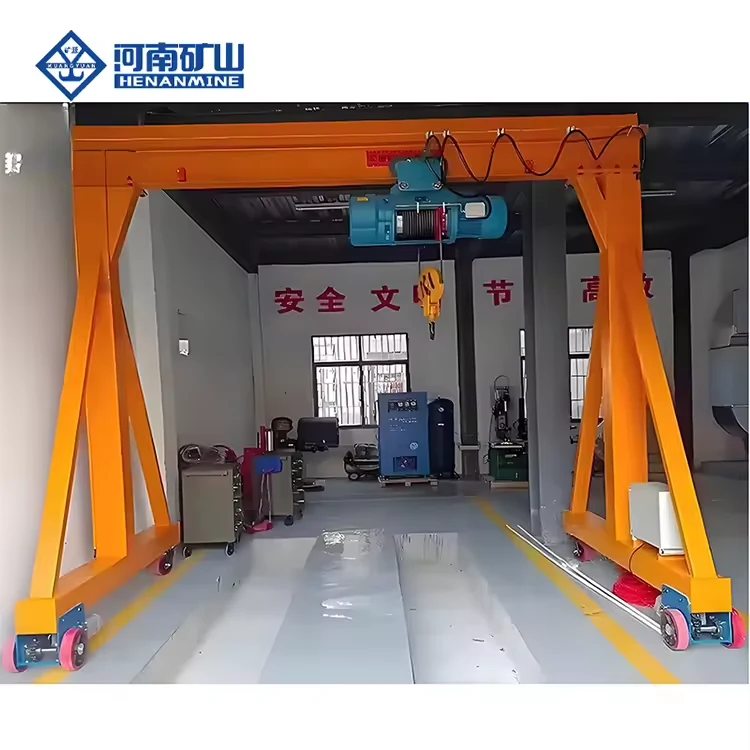Orange freestanding wheeled gantry frame with blue electric wire-rope hoist in a workshop