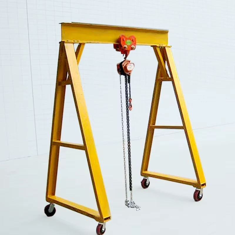 Yellow compact hand-pushed gantry frame with suspended chain hoist and four caster wheels