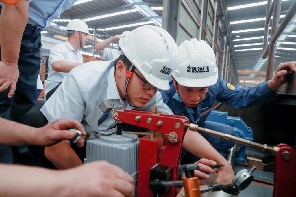 Inspectors checking a crane component during factory acceptance