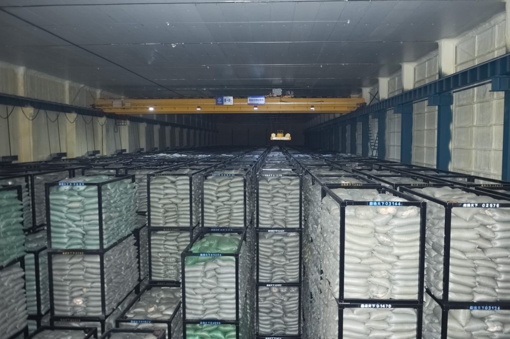Stacked storage containers inside a cold storage warehouse