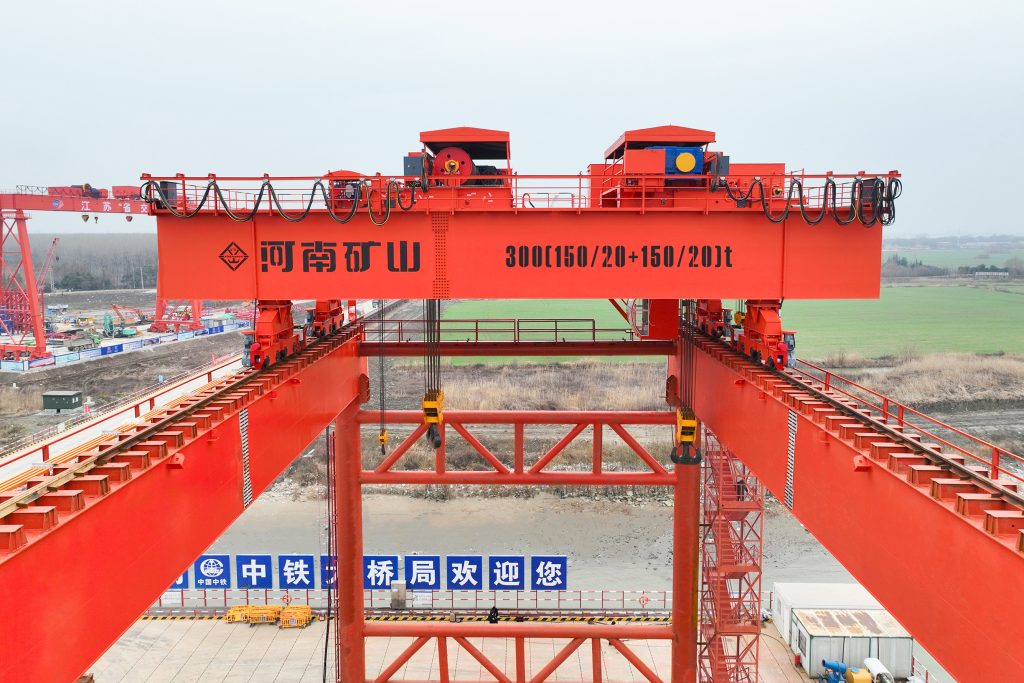 Heavy overhead crane over a bridge fabrication work area