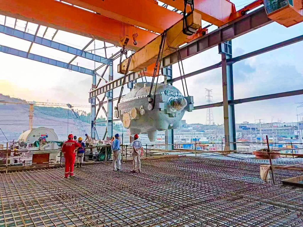 Overhead crane handling a thermal power plant installation component