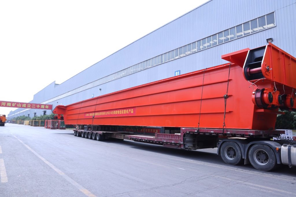 Long casting crane girder on a trailer outside the factory